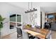Well-lit dining room with hardwood table and a view of backyard at 15379 Alperton Rd, Fishers, IN 46037