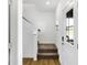 Hallway with wooden floors, a carpeted stairway with white walls, and a front door with a window at 15379 Alperton Rd, Fishers, IN 46037