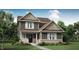 Charming two-story home with stone accents, a well-manicured lawn, and professionally landscaped shrubbery at 15379 Alperton Rd, Fishers, IN 46037