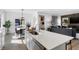 Bright open kitchen with stainless steel appliances, island, and view into the living room at 15379 Alperton Rd, Fishers, IN 46037
