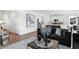 Open-concept living room and kitchen with stainless steel appliances, white cabinets, and eat-in bar at 15379 Alperton Rd, Fishers, IN 46037