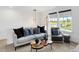 Modern loft with cozy seating, stylish lighting, and a large window overlooking the outdoors at 15379 Alperton Rd, Fishers, IN 46037