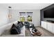 Bright, modern loft with a sofa, chair, decorative pillows, and view of neighborhood at 15379 Alperton Rd, Fishers, IN 46037