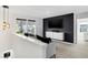 A cozy loft area is decorated with a black accent wall, modern lighting, and large windows at 15379 Alperton Rd, Fishers, IN 46037