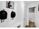 Bright mudroom boasts white wainscoting, art, storage bench, and access to a charming half bathroom at 15379 Alperton Rd, Fishers, IN 46037