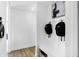 Bright mudroom boasts white wainscoting, art, and storage bench at 15379 Alperton Rd, Fishers, IN 46037