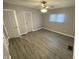 Neutral bedroom with wood-look flooring, ceiling fan with light, closet, and natural light at 1546 Kappes St, Indianapolis, IN 46221