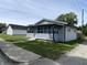 Inviting single-story home with a quaint covered porch, vinyl siding, and a well-kept lawn at 1546 Kappes St, Indianapolis, IN 46221
