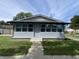 Charming house with vinyl siding, and a covered porch featuring several windows at 1546 Kappes St, Indianapolis, IN 46221