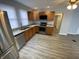 Well-lit kitchen features stainless steel appliances, granite countertops, and wooden cabinets at 1546 Kappes St, Indianapolis, IN 46221