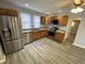 Well-lit kitchen features stainless steel appliances, granite countertops, and wooden cabinets at 1546 Kappes St, Indianapolis, IN 46221