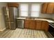 Well-equipped kitchen featuring stainless steel appliances, wood cabinets, and granite countertops at 1546 Kappes St, Indianapolis, IN 46221