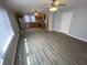 Open-concept living room features wooden floors, neutral paint, and stainless steel kitchen appliances at 1546 Kappes St, Indianapolis, IN 46221