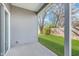 Covered back patio offers a shady outdoor space, with view of the fenced backyard and mature trees at 1616 Capra Ct, Beech Grove, IN 46107