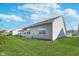 Back of the house with a manicured lawn and beautiful landscaping with a neighboring building visible at 1616 Capra Ct, Beech Grove, IN 46107
