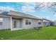 Well-maintained backyard with a sliding glass door to a small patio and vinyl siding on the house at 1616 Capra Ct, Beech Grove, IN 46107