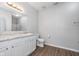 Bright bathroom featuring a vanity with white cabinets, a toilet, and a shower with a glass door at 1616 Capra Ct, Beech Grove, IN 46107