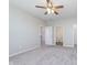 Spacious bedroom with neutral walls, ceiling fan, and doorways to the ensuite and walk-in closet at 1616 Capra Ct, Beech Grove, IN 46107
