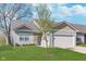 Charming single-Gathering home boasts manicured lawn and a two-car garage in a residential neighborhood at 1616 Capra Ct, Beech Grove, IN 46107