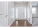 Inviting home foyer with wood-look flooring and a bright white front door with sidelights at 1616 Capra Ct, Beech Grove, IN 46107