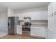Bright kitchen features stainless steel appliances, white cabinets, and an open layout for modern living at 1616 Capra Ct, Beech Grove, IN 46107