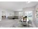 Open concept living area featuring a dining table, a sectional sofa and sliding doors with backyard views at 1616 Capra Ct, Beech Grove, IN 46107