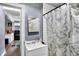 Well-lit bathroom featuring a white vanity, Eiffel Tower shower curtain, and a mirrored cabinet at 1719 Dawson St, Indianapolis, IN 46203