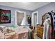 A small room with a bed, grey curtains, a tapestry, a desk, and dresser against light-blue walls at 1719 Dawson St, Indianapolis, IN 46203