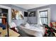 A small room with a bed, dark curtains, posters, and an entrance to another room to the left at 1719 Dawson St, Indianapolis, IN 46203
