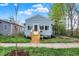 Charming single-Gathering home featuring a new wood porch and light-blue siding, landscaped yard, and sidewalk at 1719 Dawson St, Indianapolis, IN 46203