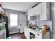 A functional kitchen with white cabinets, a stainless steel sink, and laminate flooring at 1719 Dawson St, Indianapolis, IN 46203