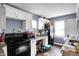 A compact kitchen with modern appliances, white cabinets, and contrasting countertop and flooring at 1719 Dawson St, Indianapolis, IN 46203