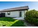 Backyard featuring a well-maintained lawn, privacy landscaping, and patio with a sliding glass door at 1720 Justin Ct, Indianapolis, IN 46219