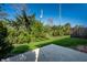 Backyard featuring lush greenery, privacy fence, and a concrete patio at 1720 Justin Ct, Indianapolis, IN 46219