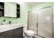 Bathroom featuring green walls, a sliding glass door shower, and a modern vanity at 1720 Justin Ct, Indianapolis, IN 46219