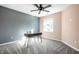 Bedroom with a ceiling fan, neutral carpet, and a desk with a window view at 1720 Justin Ct, Indianapolis, IN 46219