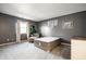 Bedroom features neutral color scheme, cozy chair, and large window at 1720 Justin Ct, Indianapolis, IN 46219