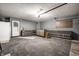 Garage with finished floors, cabinets, and a workbench area, and an exterior access door at 1720 Justin Ct, Indianapolis, IN 46219