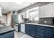 Well-lit kitchen with stainless steel appliances, dark countertops, and gray tile flooring at 1720 Justin Ct, Indianapolis, IN 46219