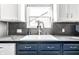 Close-up of the kitchen sink area with a modern faucet and stylish backsplash at 1720 Justin Ct, Indianapolis, IN 46219