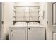 Laundry room featuring a Whirlpool washer and dryer set and shelving for storage at 1720 Justin Ct, Indianapolis, IN 46219