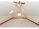 Finished attic with neutral carpet, wood trim, two ceiling fans and a window at 1853 Water Oak Ct, Avon, IN 46123