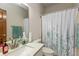 Bathroom features a granite vanity, a framed mirror, white patterned shower curtain and green towels at 1853 Water Oak Ct, Avon, IN 46123