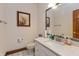 Bathroom features a granite vanity, a framed mirror, and white patterned tile floor at 1853 Water Oak Ct, Avon, IN 46123