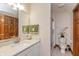 Bathroom features a granite vanity, a framed mirror, glass enclosed shower, and green towels at 1853 Water Oak Ct, Avon, IN 46123