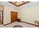 Bedroom with beige carpet has a ceiling fan and wood trim, as well as wood closet doors at 1853 Water Oak Ct, Avon, IN 46123
