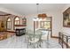 Bright dining room with fireplace, and a glass table with seating for four at 1853 Water Oak Ct, Avon, IN 46123