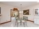 Breakfast nook with tile floors, glass top dining table and view into living room at 1853 Water Oak Ct, Avon, IN 46123