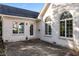 Exterior view of white brick home with stone patio, arched windows, and black roof at 1853 Water Oak Ct, Avon, IN 46123