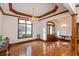 Elegant foyer with hardwood floors, ornate chandelier, and a grand wooden front door at 1853 Water Oak Ct, Avon, IN 46123
